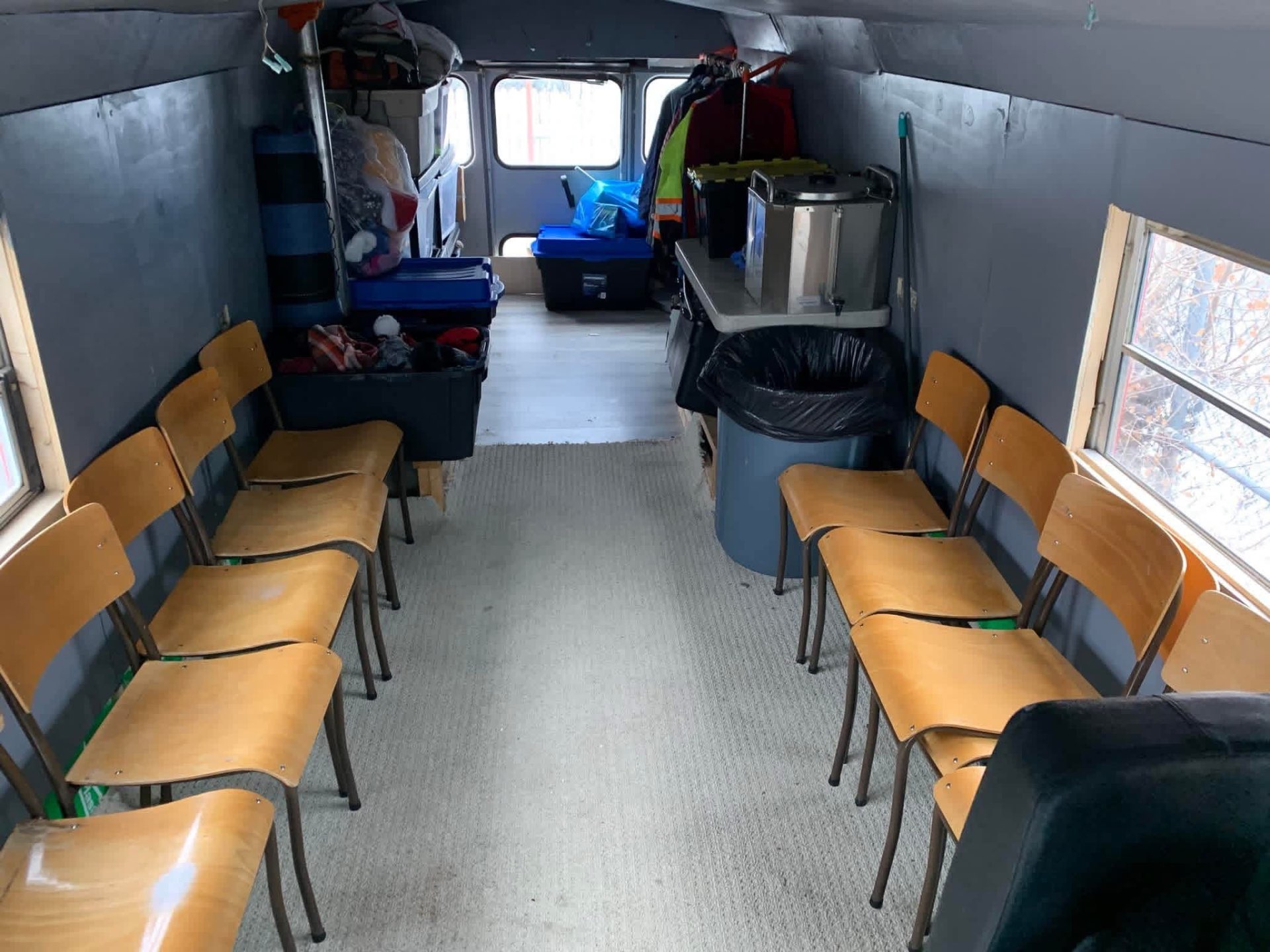Wooden chairs lining the inside of the bus