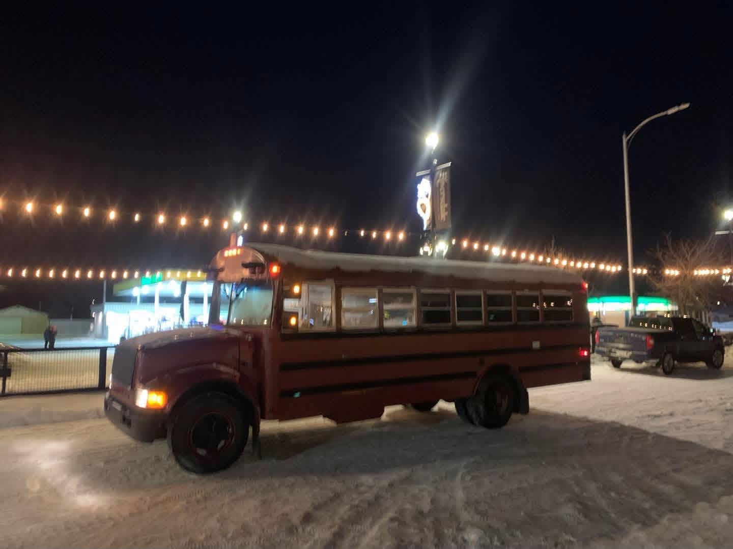 Bus under string lights at night